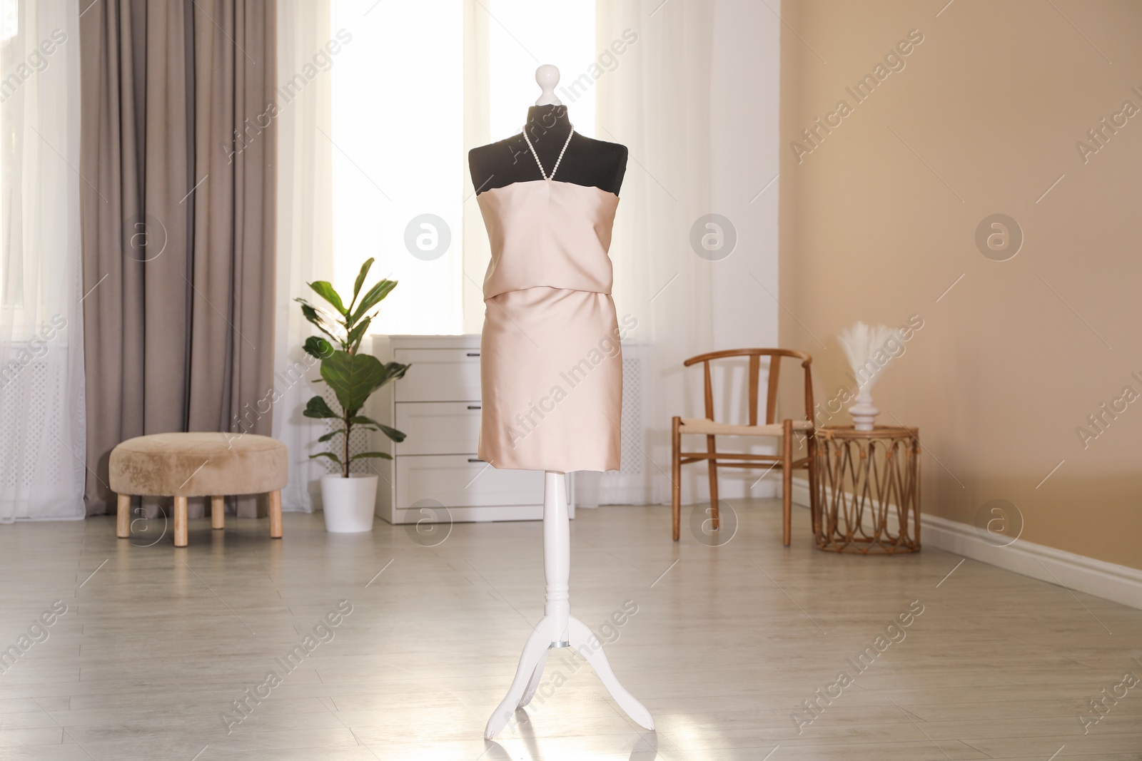 Photo of One female mannequin with unfinished dress in workshop