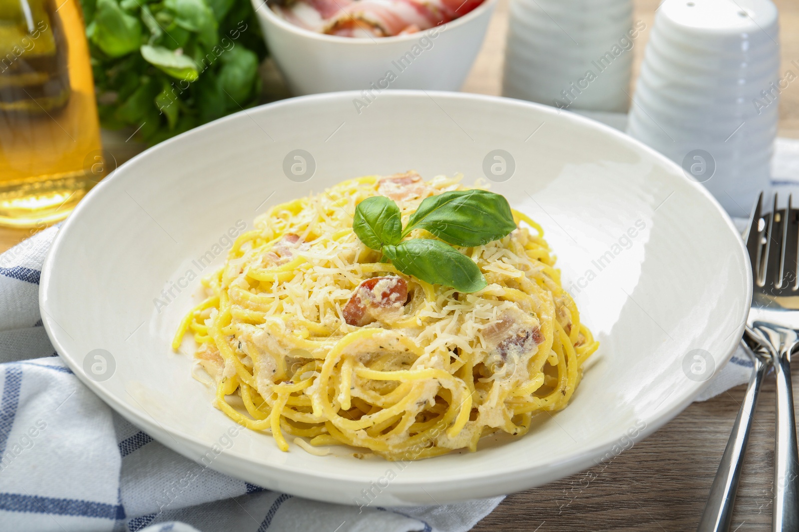 Photo of Delicious pasta Carbonara served on table, closeup