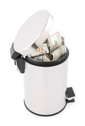 Photo of Dollar banknotes in trash bin on white background