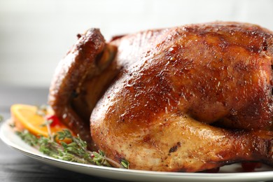 Photo of Delicious baked turkey and thyme on table, closeup