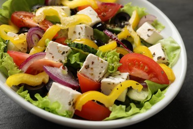 Photo of Delicious fresh Greek salad in bowl on table, closeup