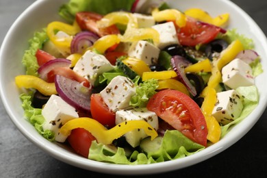 Photo of Delicious fresh Greek salad in bowl on table, closeup