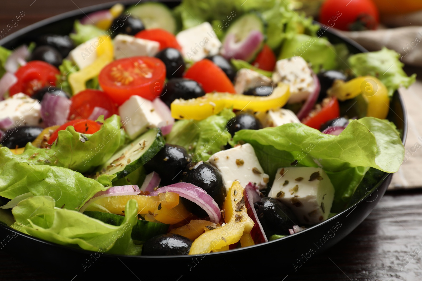 Photo of Delicious fresh Greek salad on table, closeup