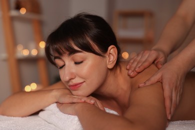 Young woman receiving massage in spa salon