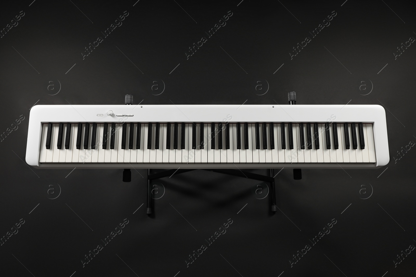 Photo of Synthesizer on black background, top view. Electronic musical instrument