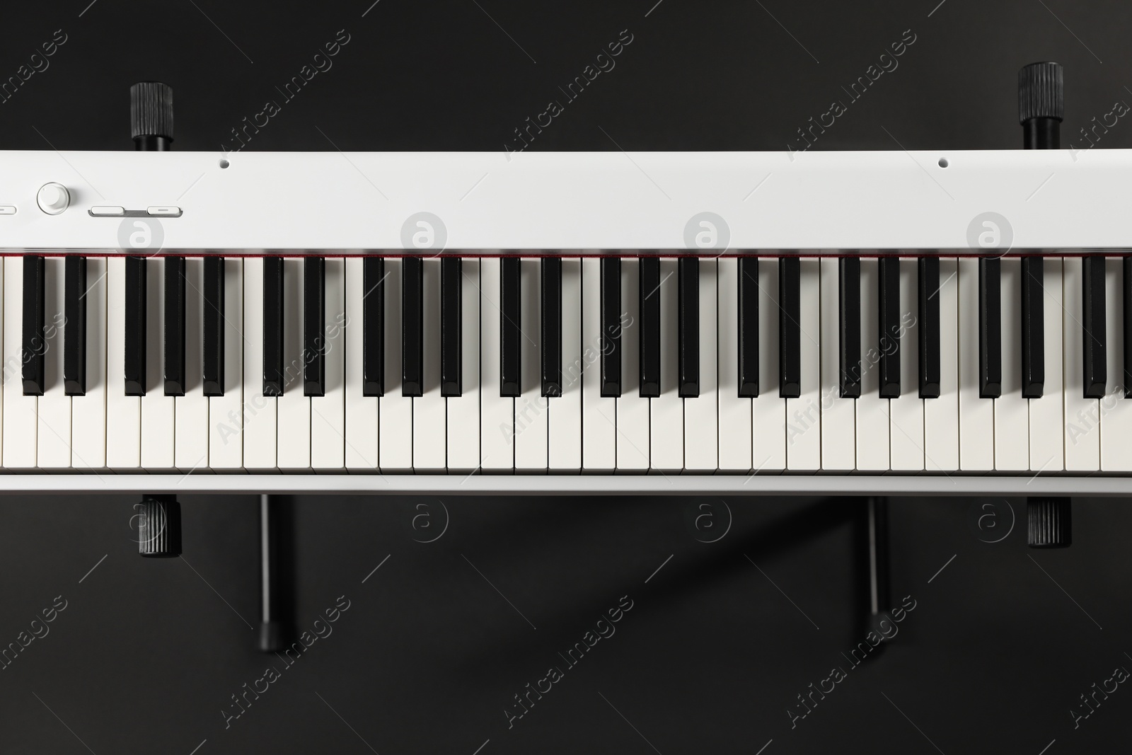 Photo of Synthesizer on black background, top view. Electronic musical instrument