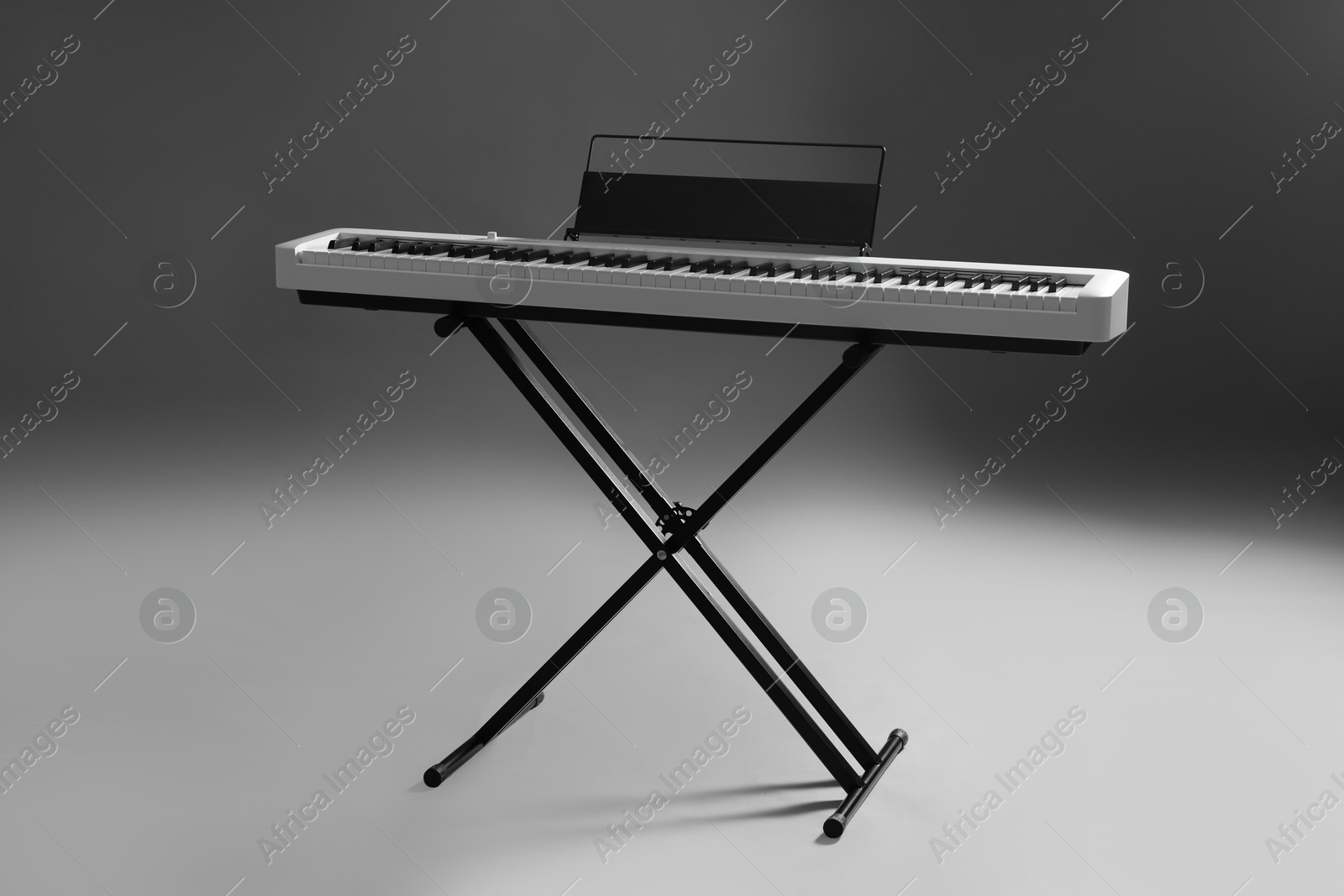 Photo of Synthesizer on grey background. Electronic musical instrument