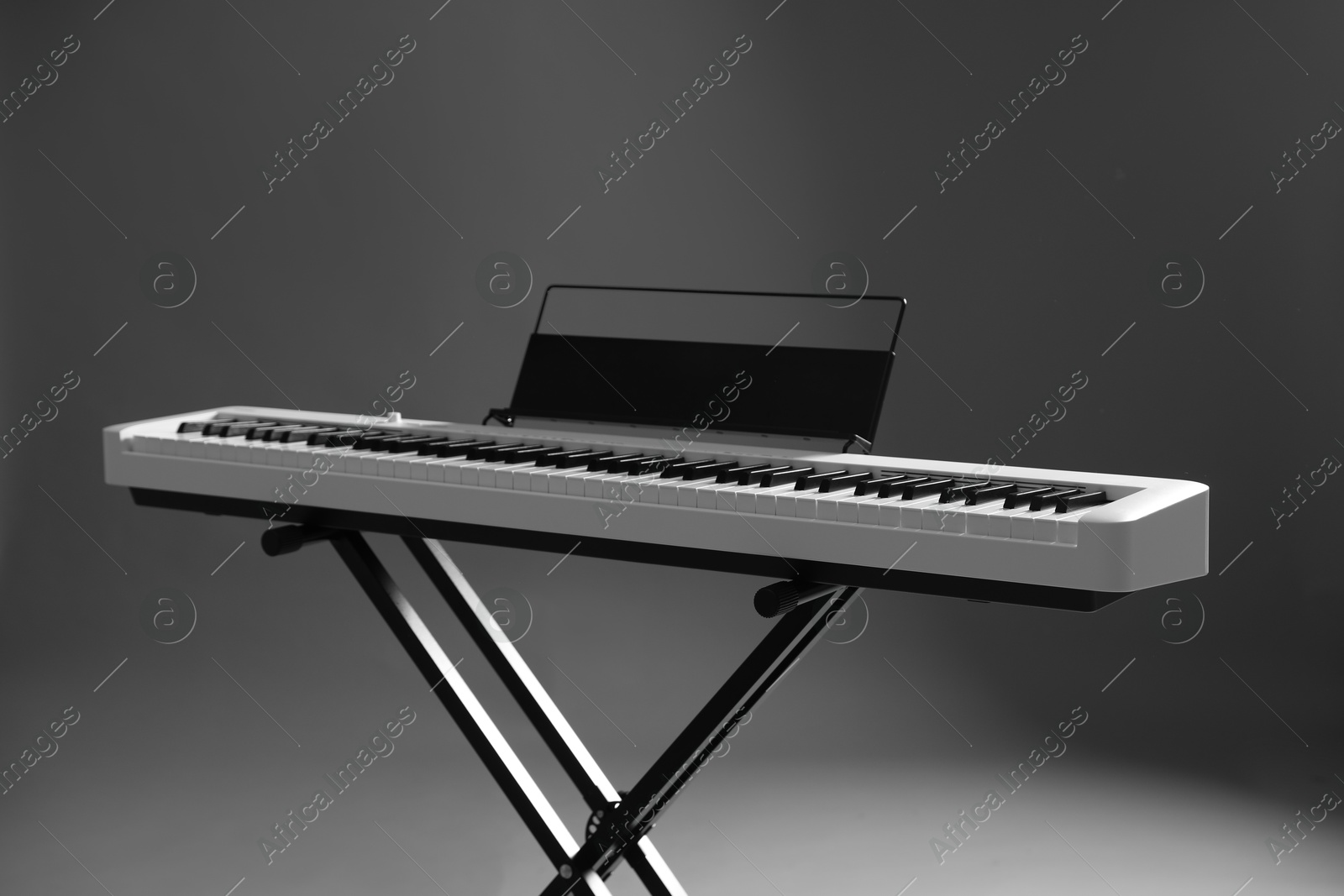 Photo of Synthesizer on grey background. Electronic musical instrument