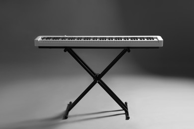 Photo of Synthesizer on grey background. Electronic musical instrument