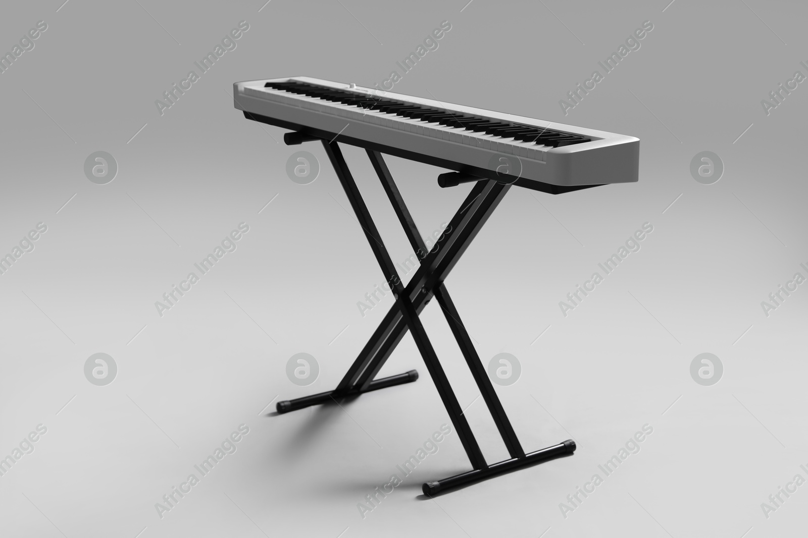 Photo of Synthesizer on grey background. Electronic musical instrument