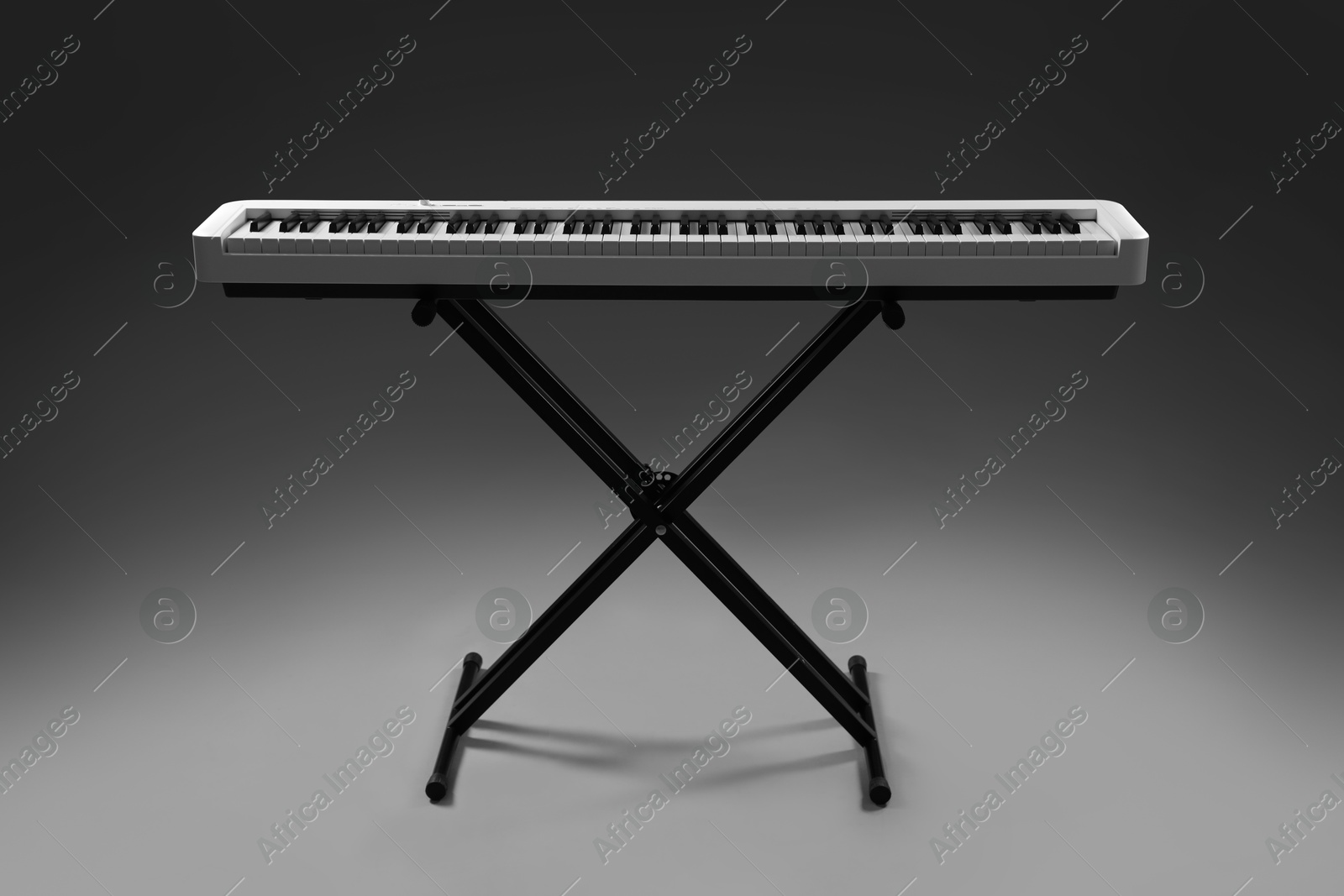 Photo of Synthesizer on grey background. Electronic musical instrument