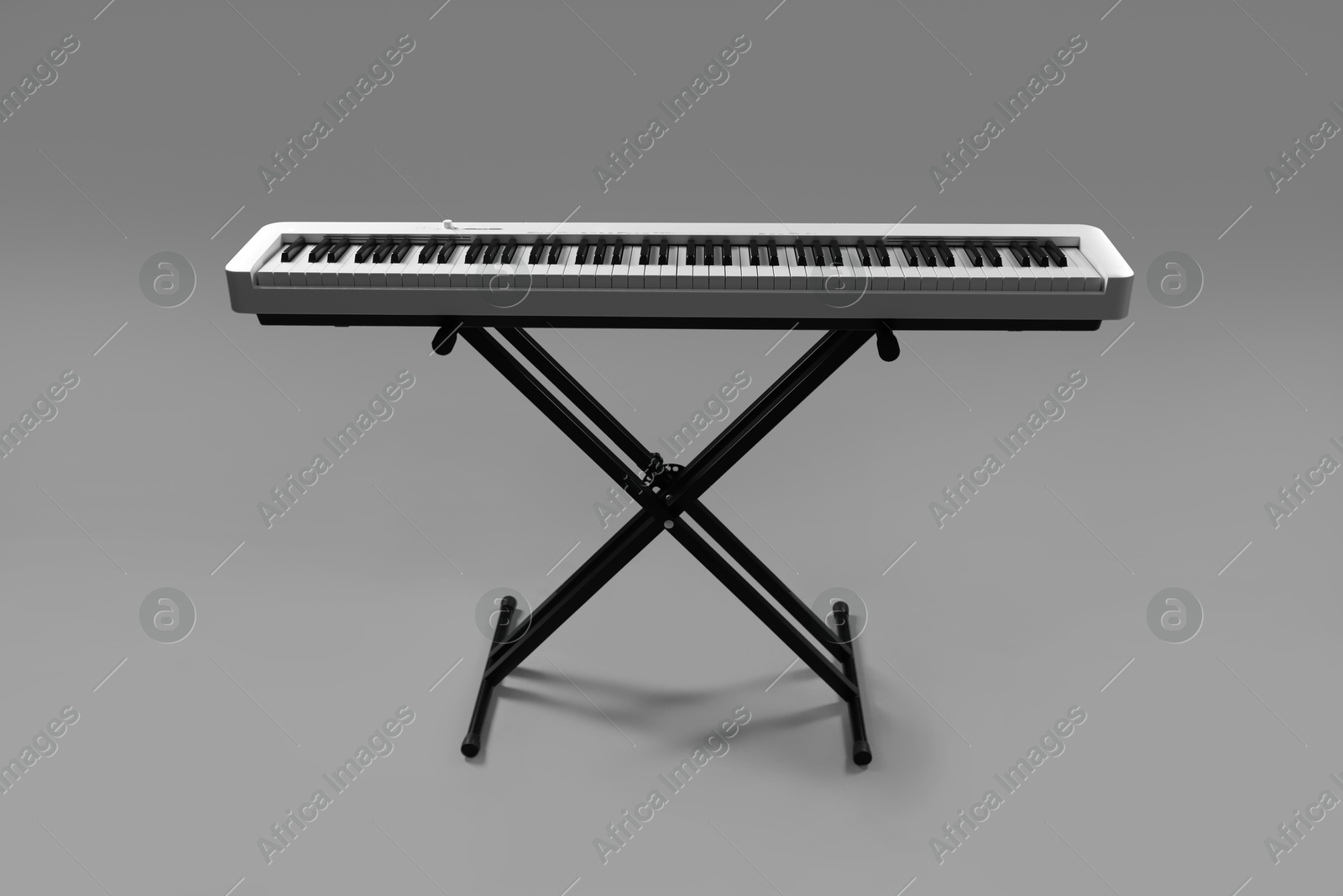 Photo of Synthesizer on grey background. Electronic musical instrument