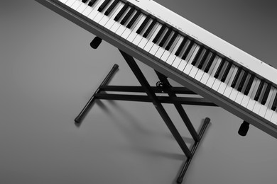 Photo of Synthesizer on grey background, above view. Electronic musical instrument