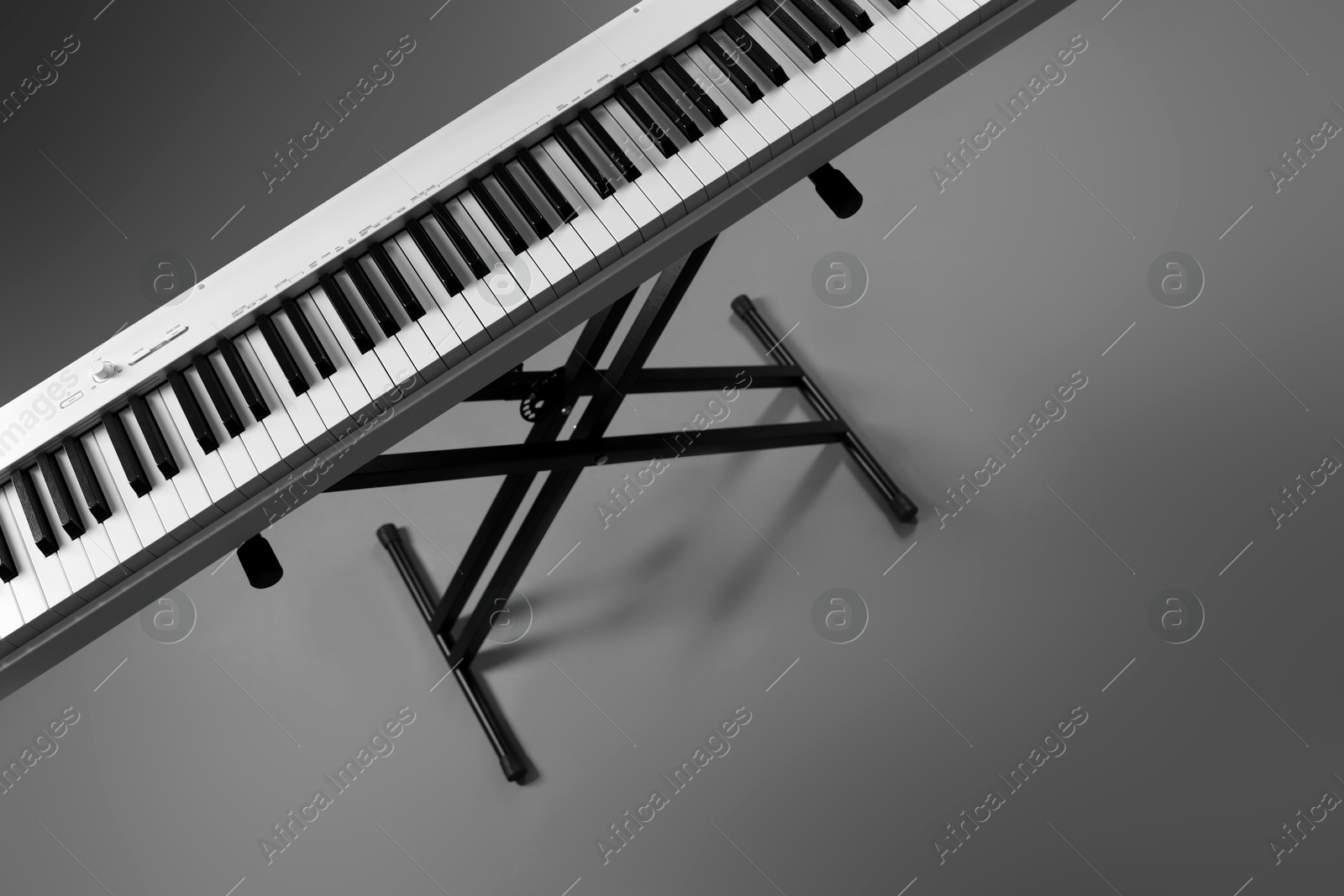 Photo of Synthesizer on grey background, above view. Electronic musical instrument