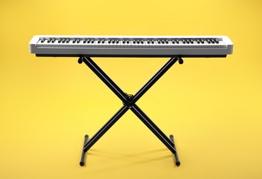 Photo of Synthesizer on yellow background. Electronic musical instrument