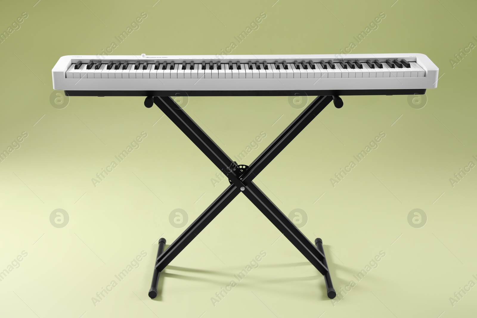 Photo of Synthesizer on green background. Electronic musical instrument