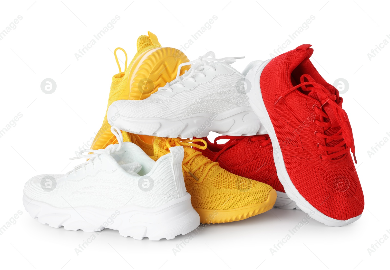 Photo of Pile of colorful sneakers isolated on white