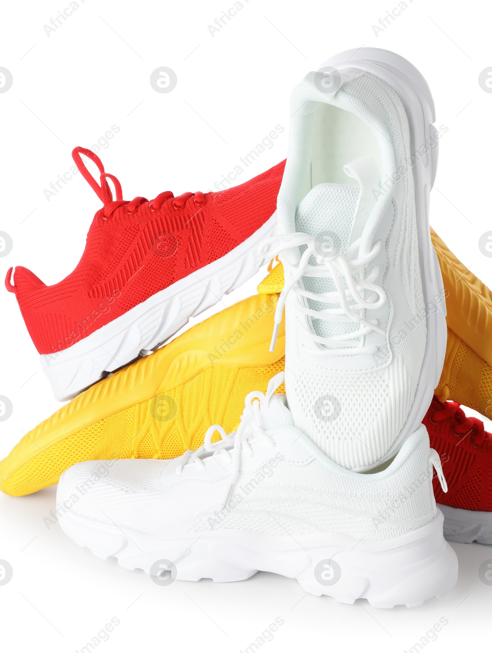 Photo of Pile of colorful sneakers isolated on white