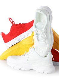 Photo of Pile of colorful sneakers isolated on white