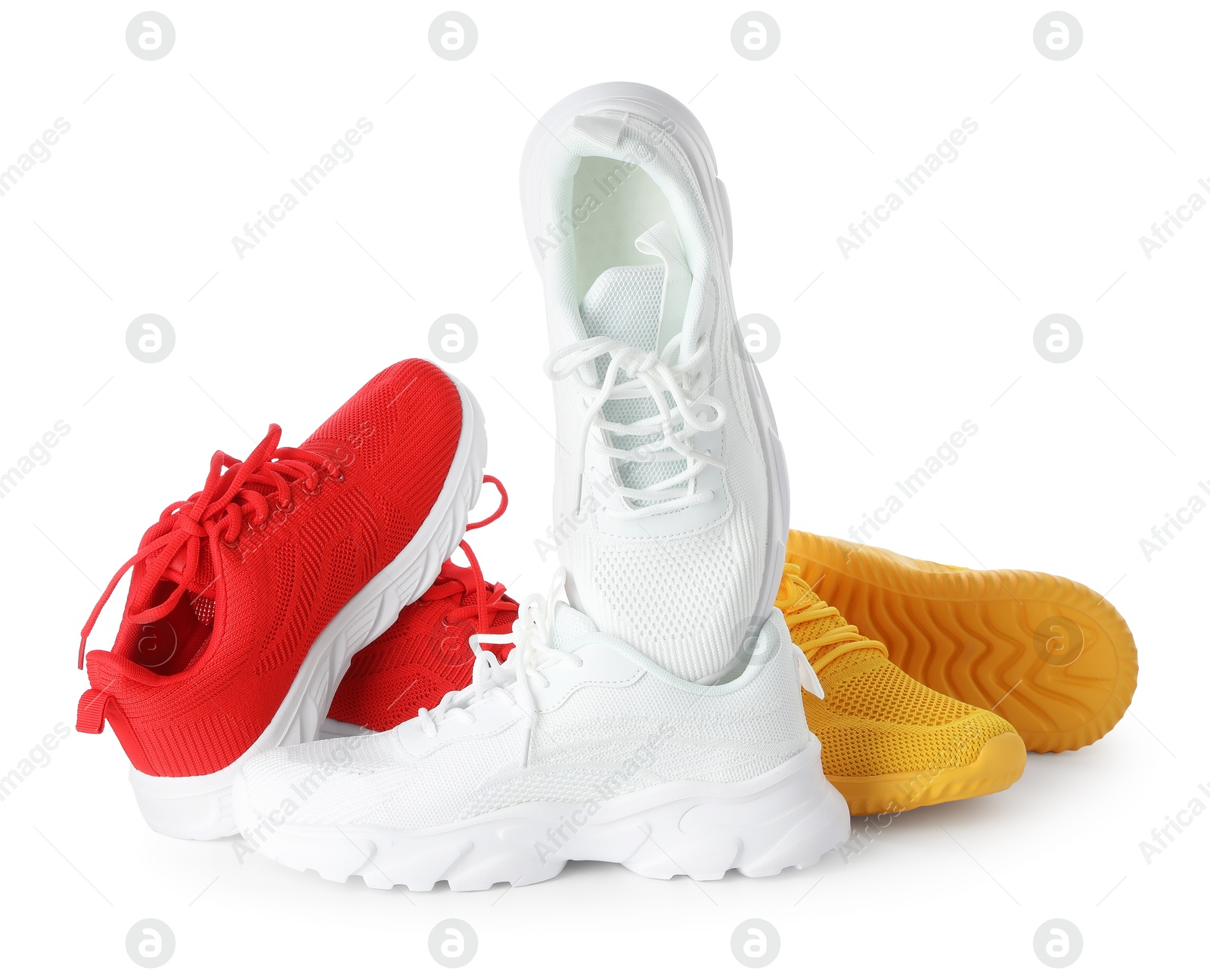 Photo of Pile of colorful sneakers isolated on white