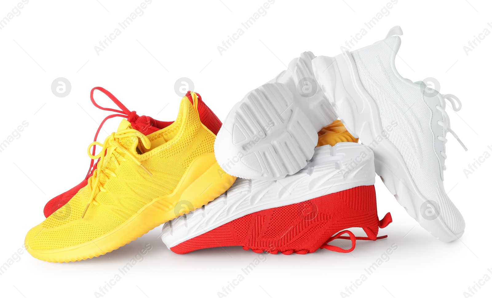 Photo of Pile of colorful sneakers isolated on white