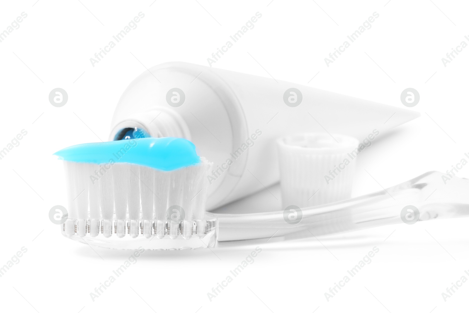 Photo of Toothbrush with toothpaste and tube isolated on white