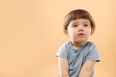 Photo of Portrait of cute little boy on beige background. Space for text