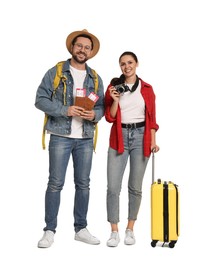 Photo of Tourism. Happy couple with passports, tickets, camera and suitcase on white background