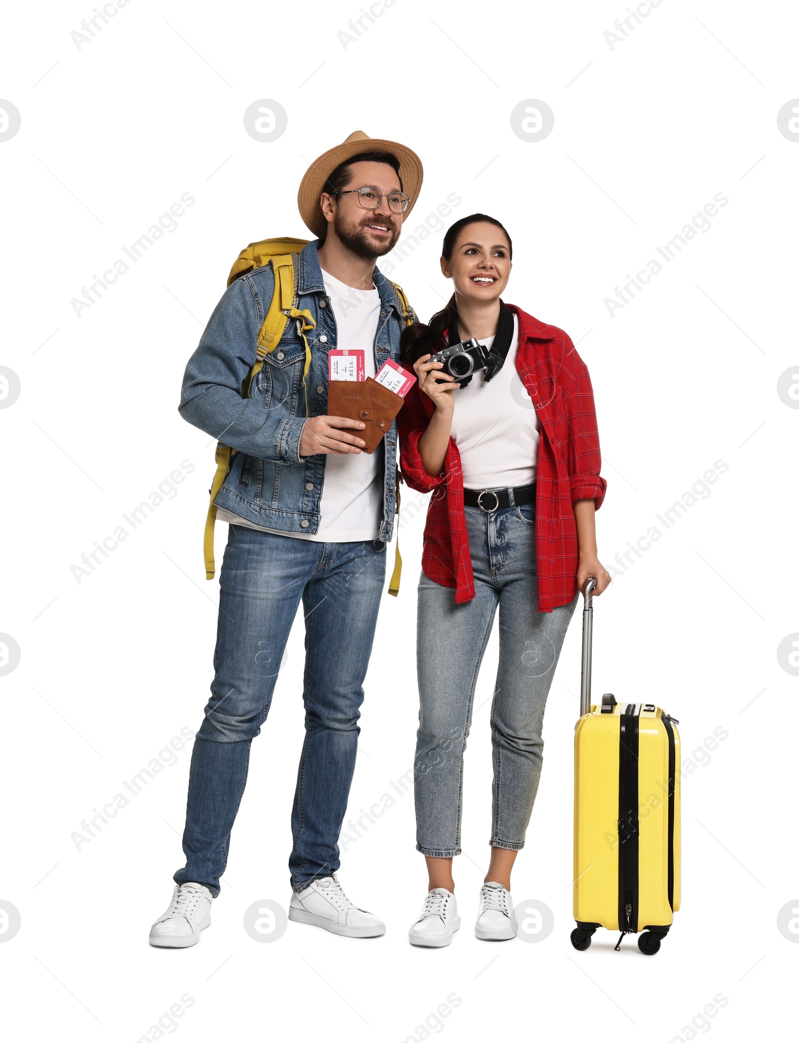 Photo of Tourism. Happy couple with passports, tickets, camera and suitcase on white background