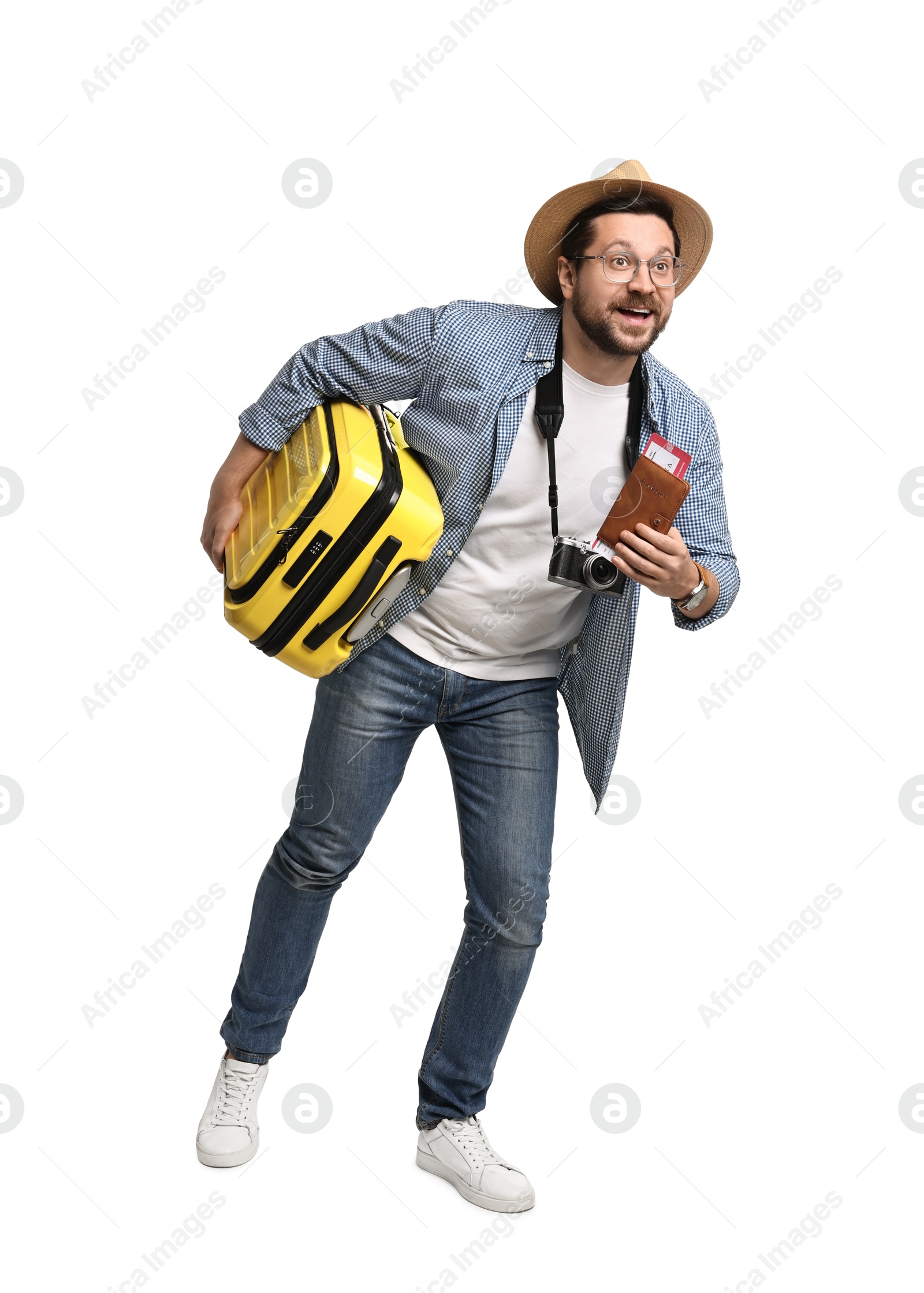 Photo of Happy tourist in hat with suitcase, passport and ticket on white background