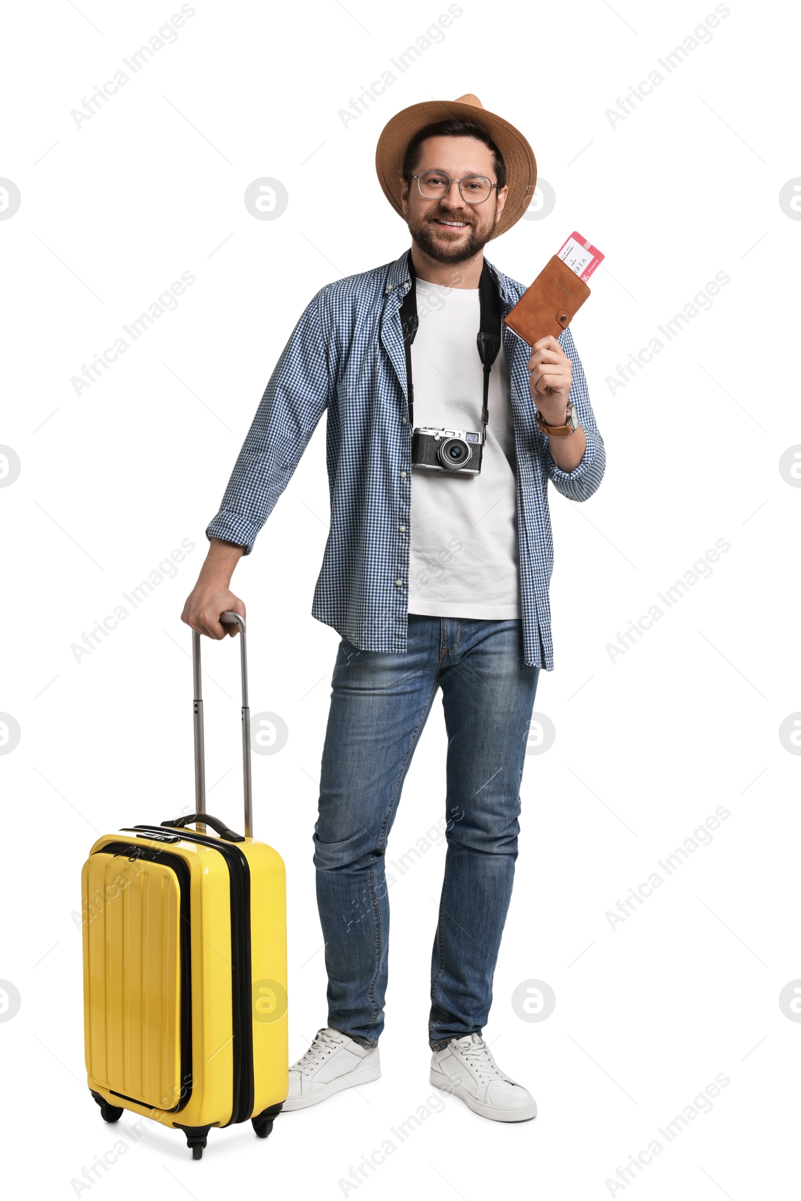 Photo of Happy tourist in hat with suitcase, passport and ticket on white background