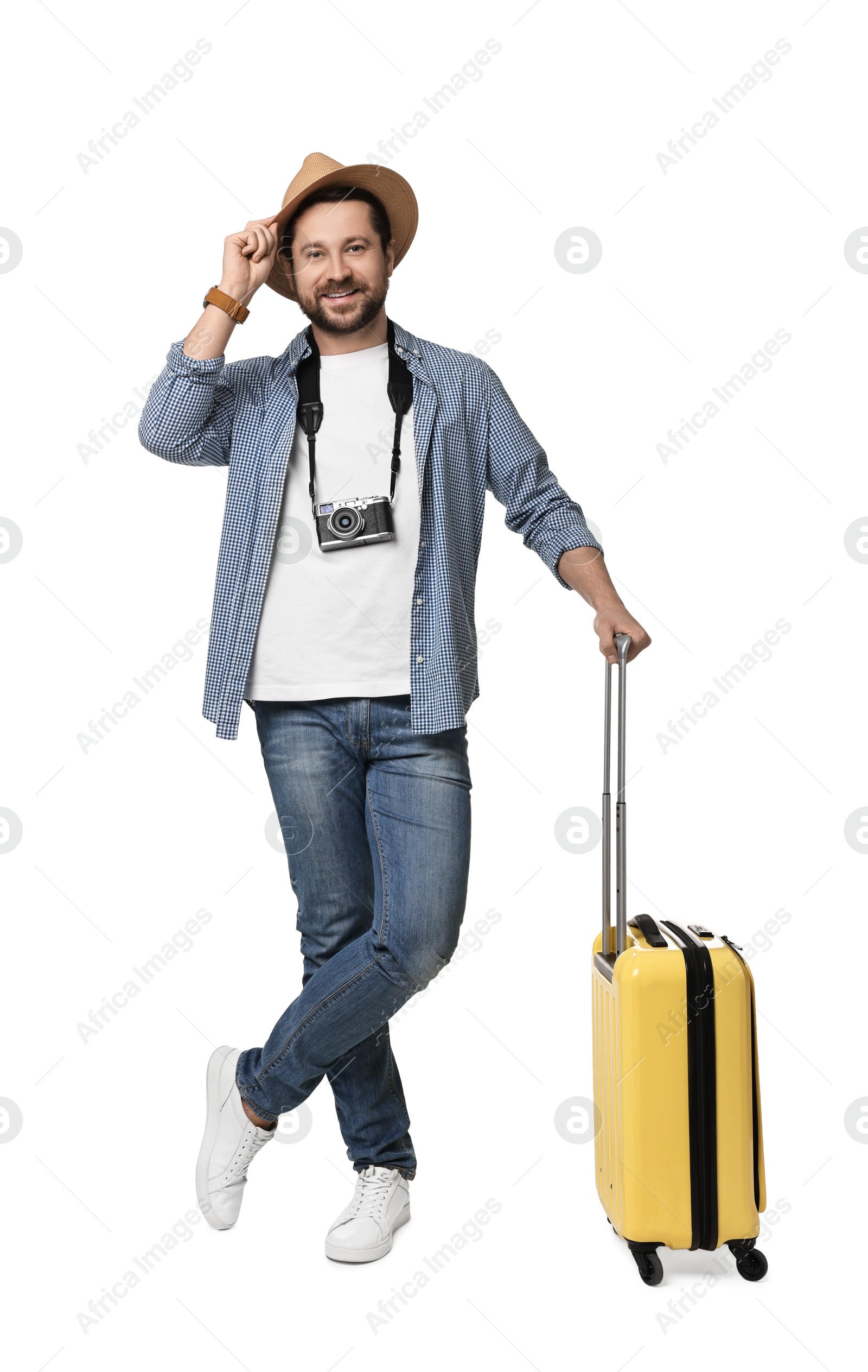 Photo of Happy tourist in hat with suitcase and camera on white background