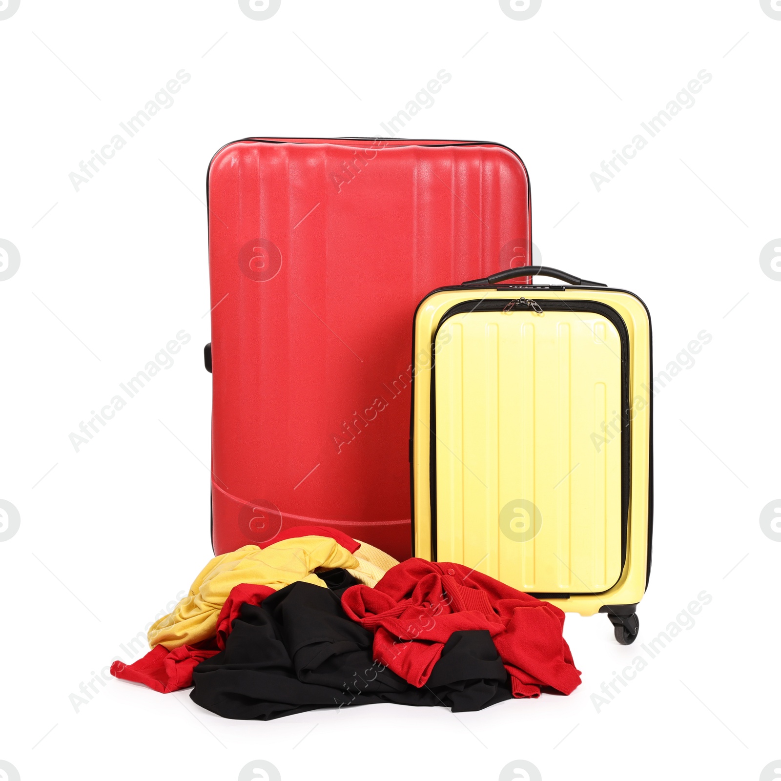 Photo of Suitcases and messy pile of clothes isolated on white