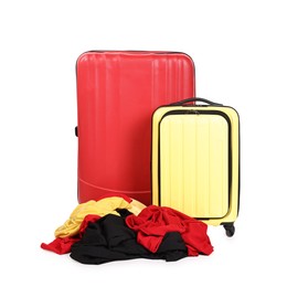 Photo of Suitcases and messy pile of clothes isolated on white