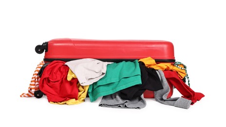 Photo of Packed suitcase full of clothes isolated on white