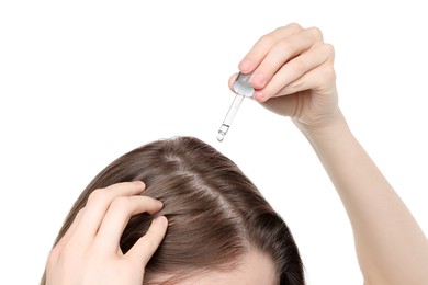 Photo of Hair loss problem. Girl applying serum onto hairline on white background, closeup