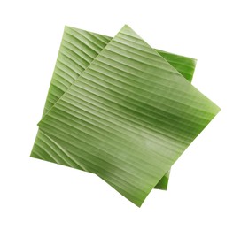 Photo of Pieces of banana leaves isolated on white, top view. Traditional meal serving