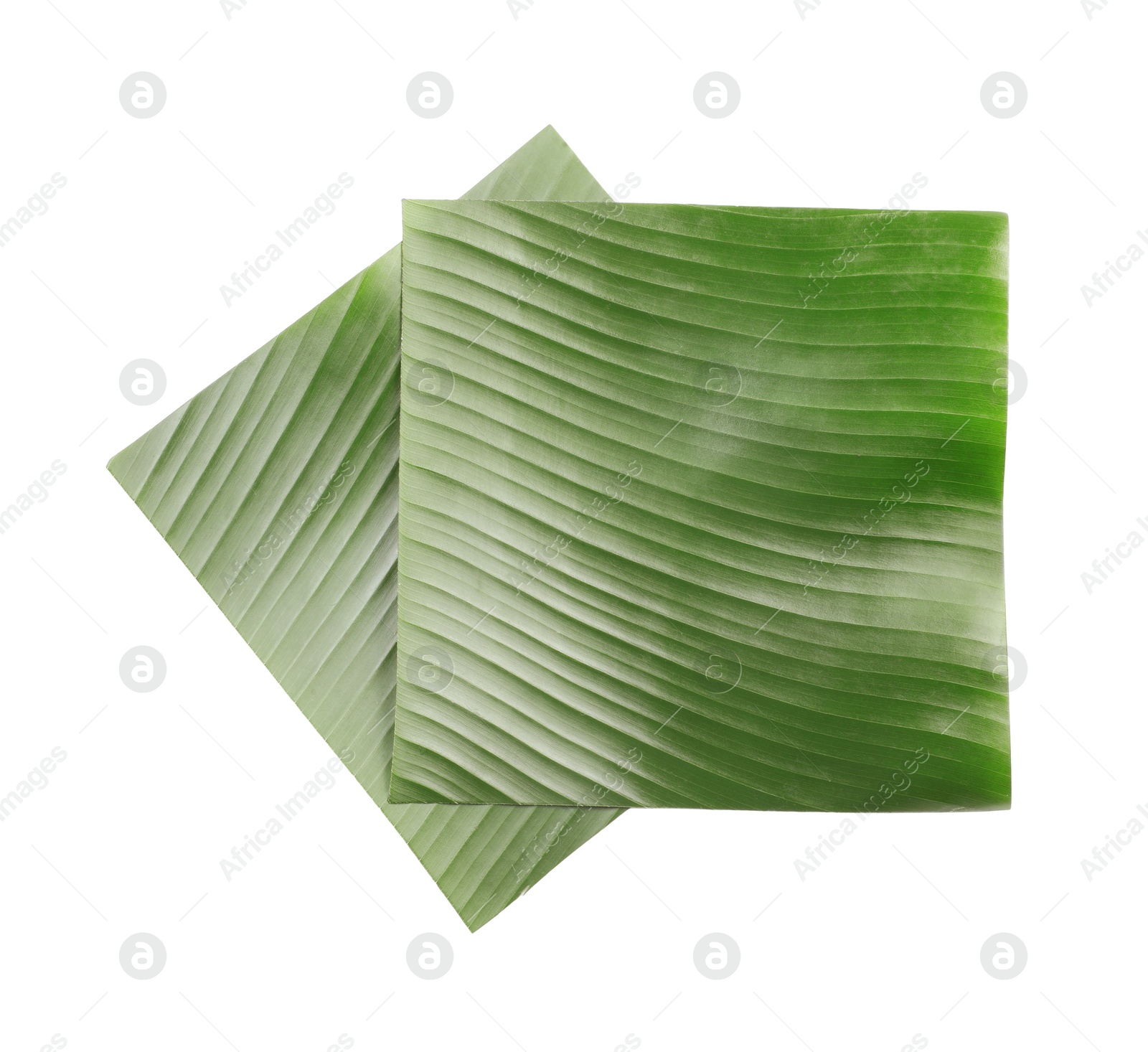 Photo of Pieces of banana leaves isolated on white, top view. Traditional meal serving