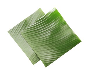 Photo of Pieces of banana leaves isolated on white, top view. Traditional meal serving