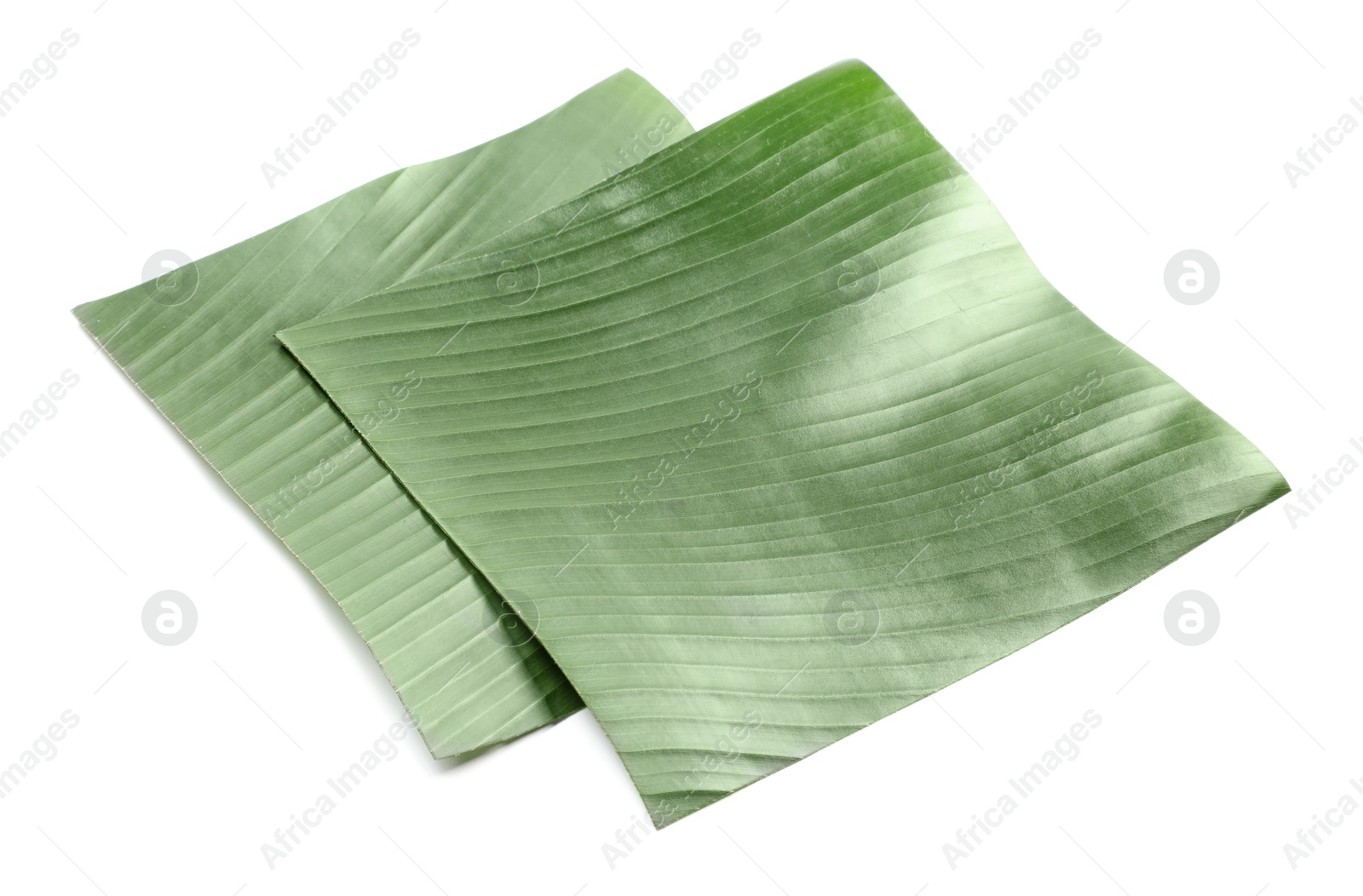 Photo of Pieces of banana leaves isolated on white. Traditional meal serving