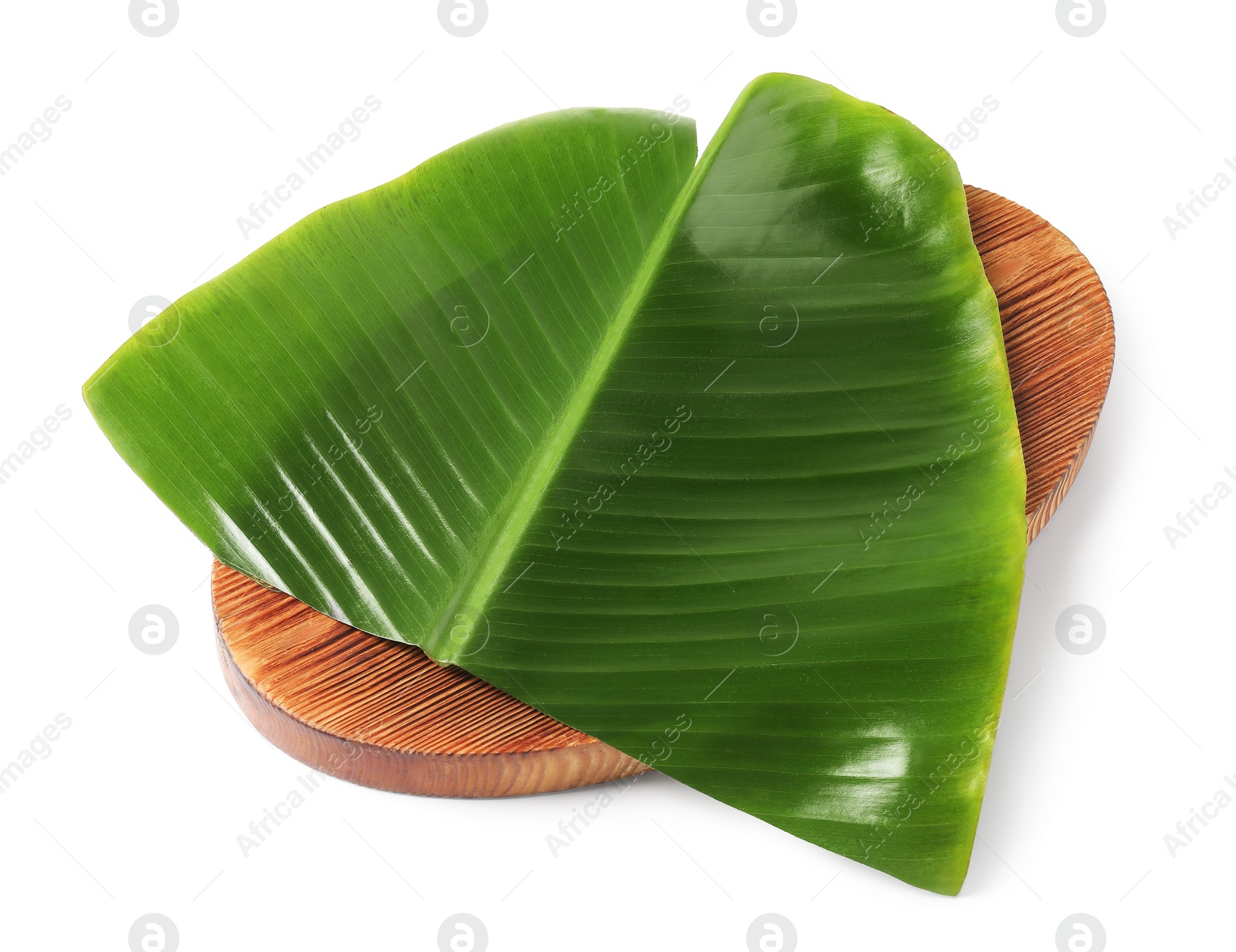 Photo of Board with cut banana leaf isolated on white. Healthy eco serving