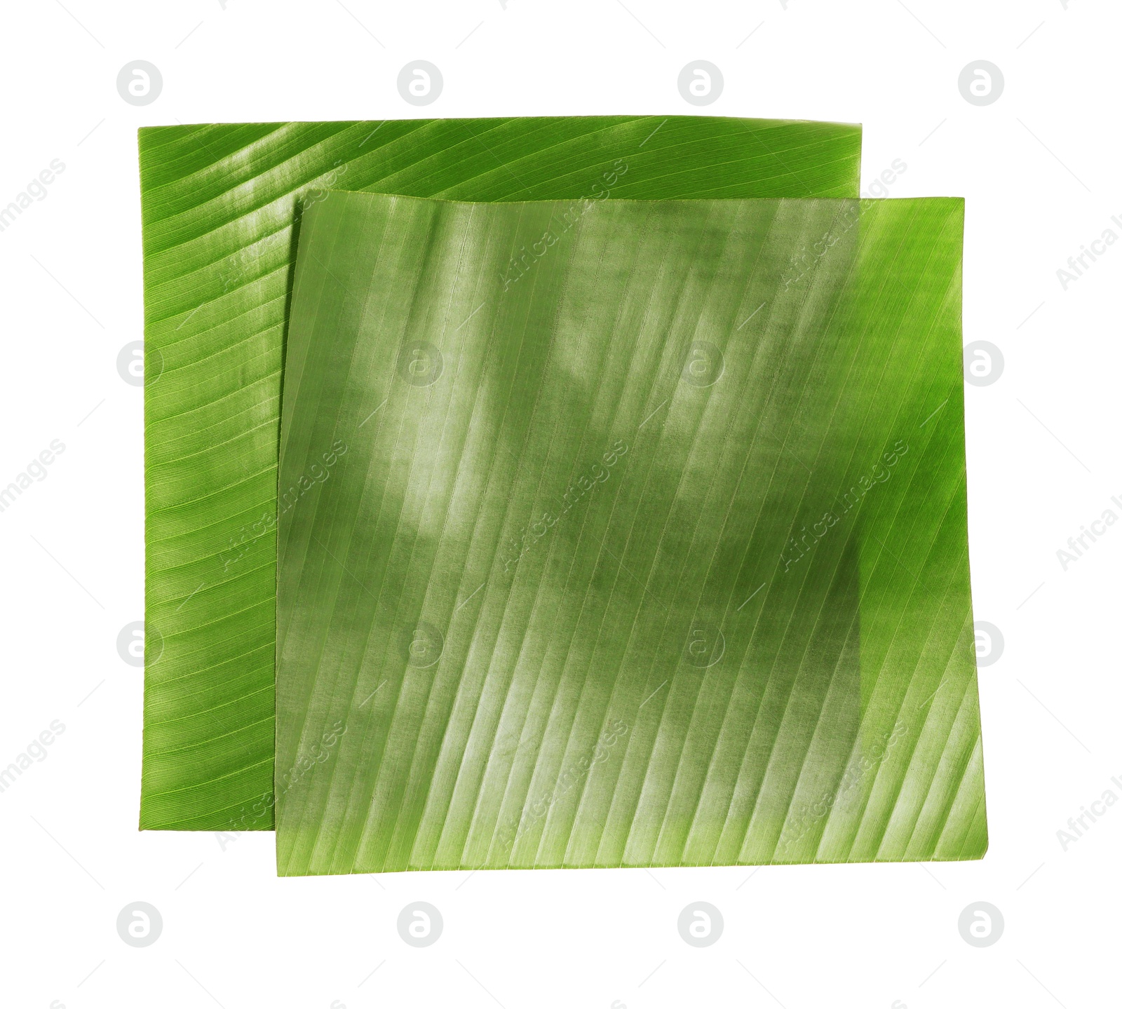 Photo of Pieces of banana leaves isolated on white, top view. Traditional meal serving