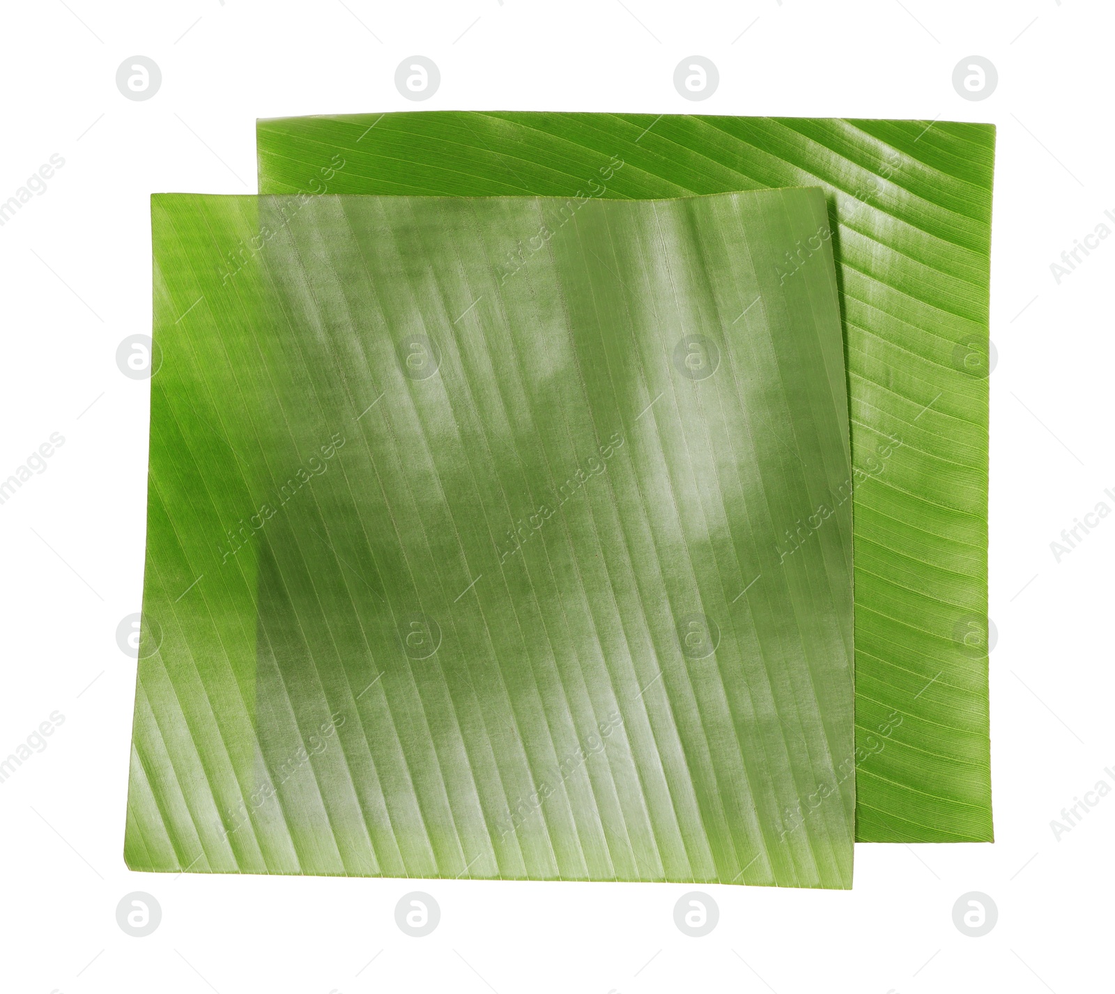 Photo of Pieces of banana leaves isolated on white, top view. Traditional meal serving