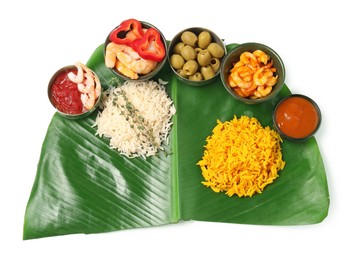 Photo of Cut banana leaf with different food and sauces isolated on white, top view. Healthy eco serving