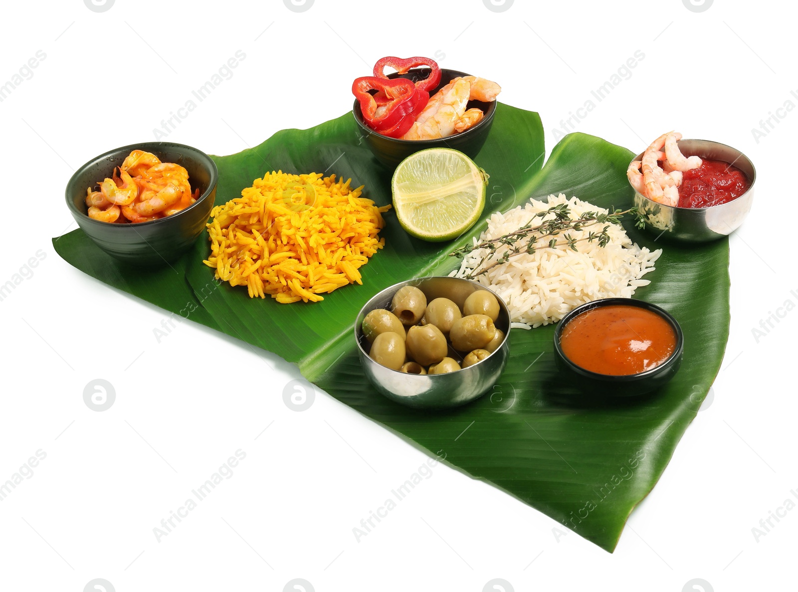 Photo of Cut banana leaf with different food and sauces isolated on white. Healthy eco serving