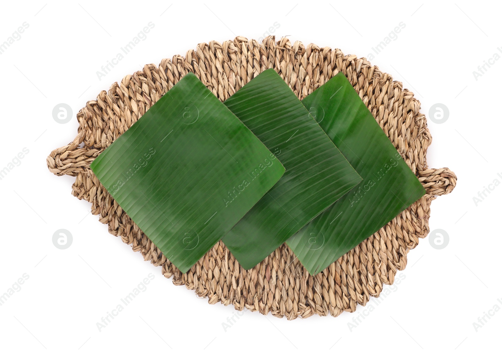 Photo of Pieces of banana leaves isolated on white, top view. Traditional meal serving