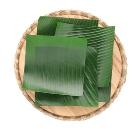 Photo of Pieces of banana leaves isolated on white, top view. Traditional meal serving