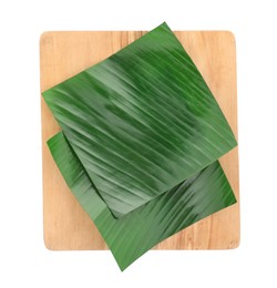 Photo of Pieces of banana leaves isolated on white, top view. Traditional meal serving