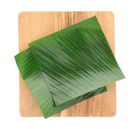 Photo of Pieces of banana leaves isolated on white, top view. Traditional meal serving