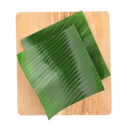 Photo of Pieces of banana leaves isolated on white, top view. Traditional meal serving